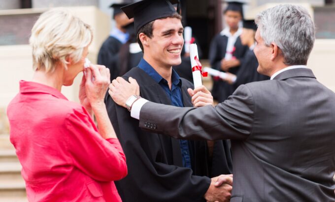 Handsome,Male,Graduate,Being,Congratulated,By,His,Father,At,Graduation