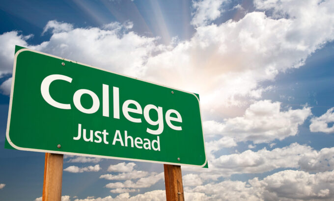 College,Just,Ahead,Green,Road,Sign,With,Dramatic,Clouds,,Sun