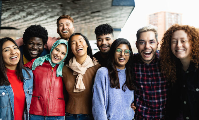 Young multi ethnic friends having fun together hanging out in the city - Friendship and diversity concept