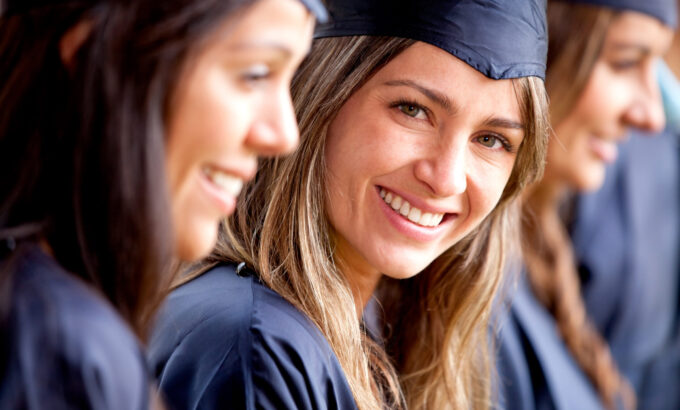 Beautiful,Female,Graduate,Standing,Out,From,A,Group,Of,Students